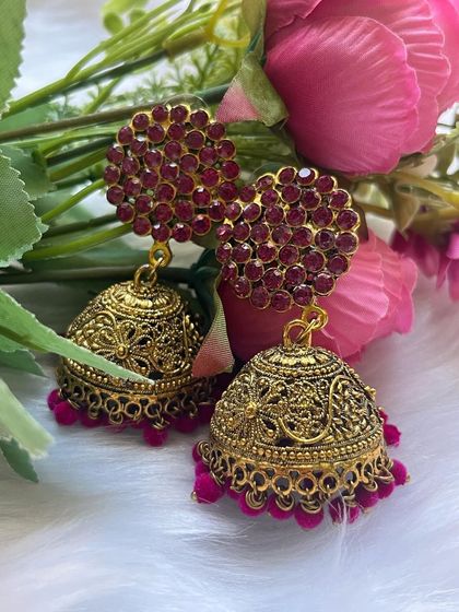 Various shots of the large pink stone stud jhumkas, showcasing their sparkle and rich color against different backdrops.