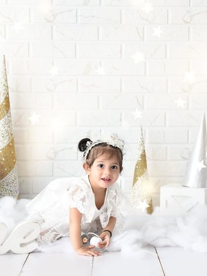 A dreamy, all-white winter theme for a magical first birthday. The soft textures and sparkly star details make this a truly special setup.