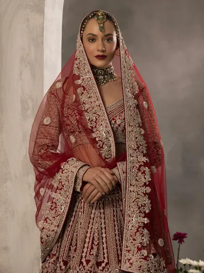 A classic bridal portrait featuring a deep red lehenga with intricate silver embroidery. I styled this look with a traditional matha patti and a bold lip to create a sense of timeless, regal beauty, perfect for a heritage-themed wedding.
