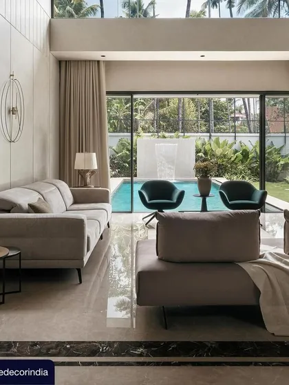 Another image from the Elle Decor feature, this one showing the family living area at Villa Shakthi overlooking the pool. The design emphasizes the indoor-outdoor connection, a key theme of this contemporary tropical home.