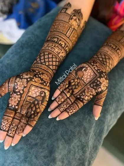 A close-up of the bridal mehndi with peacock figures, showing the fine details and sharp lines.