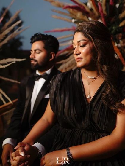 A candid moment of the couple during their evening celebration. The backdrop we designed with pampas grass and a rich maroon fabric created a warm, rustic, and elegant setting for their photos.