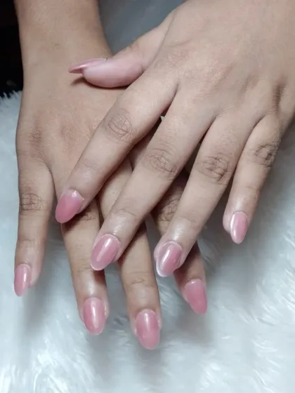 A simple and pretty set of almond-shaped extensions with a semi-sheer, glossy pink polish.