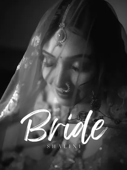 A timeless black and white portrait of Shalini, her face partially veiled, her expression soft and gentle.
