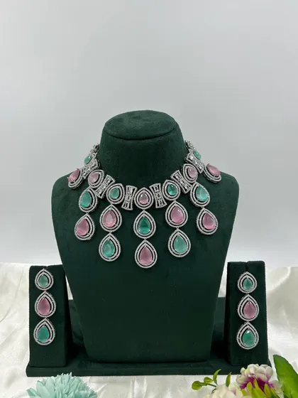 The same teardrop necklace design with two-tone pink and green stones.