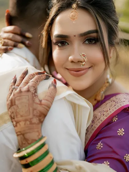 We take pride in creating authentic regional looks. This close-up of a Maharashtrian bride showcases the subtle makeup, traditional accessories, and the beautiful details that honor her heritage.