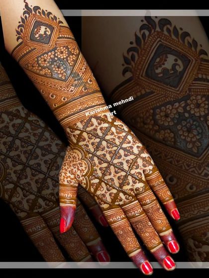 A design for the back of the hand, featuring intricate jaali work and a small elephant motif. The geometric precision and delicate floral elements showcase a high level of skill.