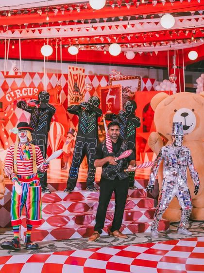 A fantastic group shot of the performers, including a giant teddy bear, a clown, and LED jugglers. The entertainment is a crucial part of the immersive experience I create.