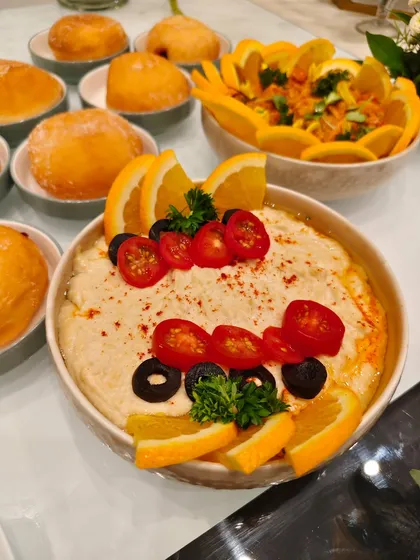 Classic hummus, dressed to impress. Our creamy dip is topped with fresh tomatoes, olives, and orange slices for a burst of freshness in every bite.