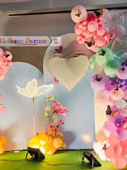 A detailed shot of the butterfly balloon garland and the heart-shaped backdrop piece.