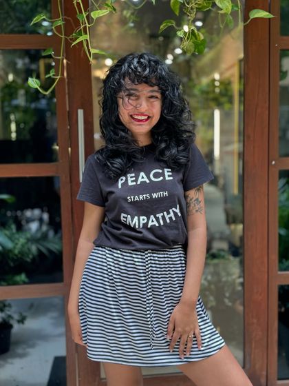Curly bangs are the cutest! This client is radiating joy with her new fringe and layered cut that perfectly frames her smiling face.