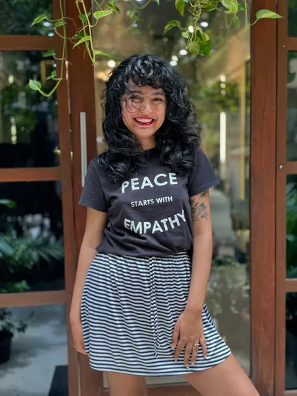 Curly bangs are the cutest! This client is radiating joy with her new fringe and layered cut that perfectly frames her smiling face.