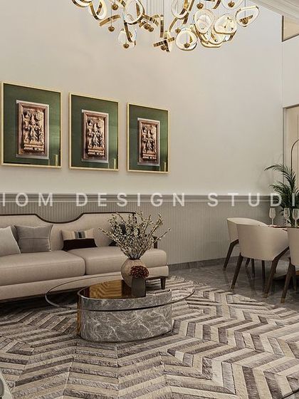 Another neoclassical living and dining area, where a chevron-patterned rug grounds the seating area. A glass partition with a classic arch-inspired pattern separates the dining space.
