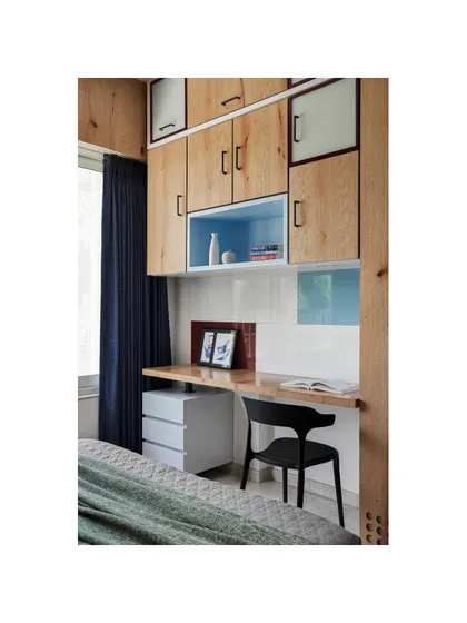 A custom study table in the teenager's room uses veneer and colored glass in geometric patterns, creating an interesting and functional space for study and hobbies.