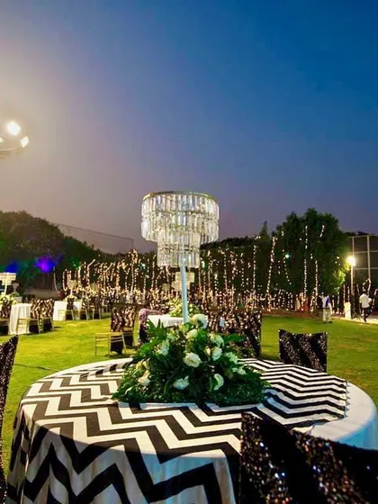 The guest seating area was just as important as the main stage. We used tables with chevron-patterned linens, sequined chair covers, and crystal chandelier centerpieces to create a cohesive and glamorous look.