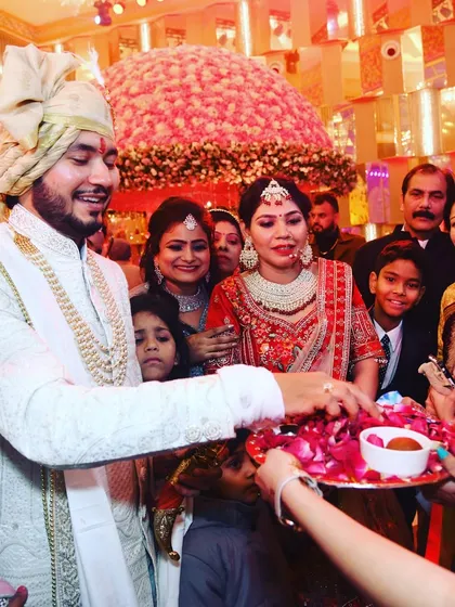 Another moment from the welcome ceremony, capturing the couple's interaction with their family. These are the real, candid moments of the day.