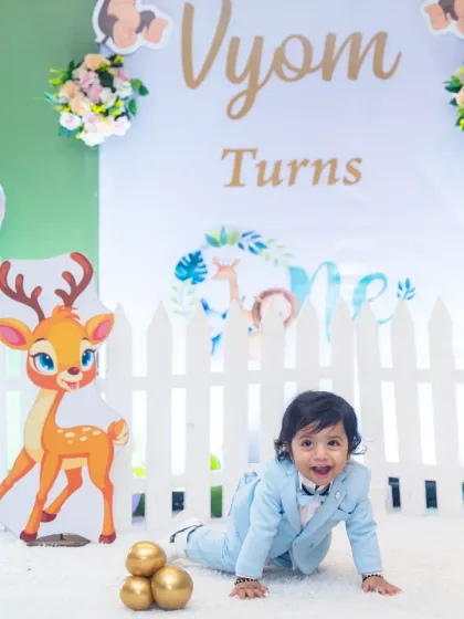 A playful photo of the birthday boy crawling towards the camera during his jungle-themed first birthday party.