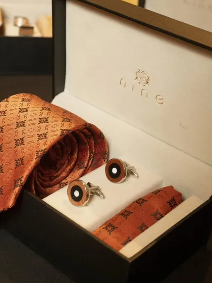 This is one of our most popular accessory gift sets, perfect for premium corporate gifting. It features a silk tie with a traditional motif, matching cufflinks, and a pocket square, all presented in our signature branded box.