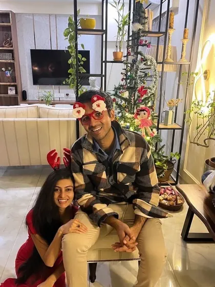 A happy client couple celebrating Christmas in their newly designed living room.