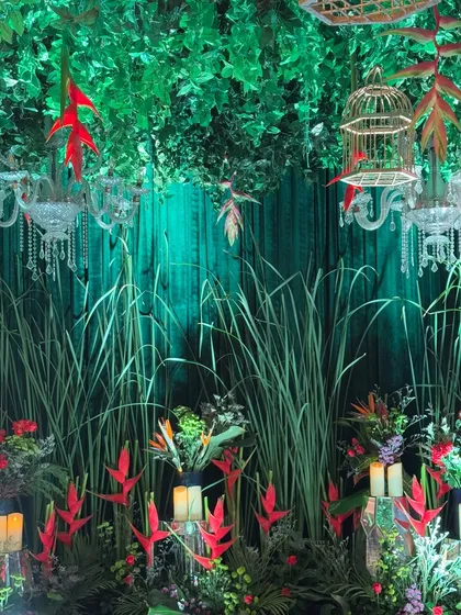 Videos showcasing the "Enchanted Garden" entrance, with its mix of lush greenery, pops of red flowers, and whimsical elements like hanging birdcages.