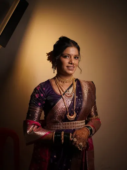 A smiling portrait of the bride, looking confident and beautiful. The makeup is a perfect balance of tradition and modernity.