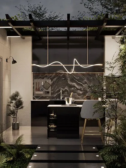 A luxury terrace design featuring a sleek, modern outdoor kitchen and bar. The space is defined by its dramatic marble accent walls, designer lighting, and a stepping stone path through lush ground cover.