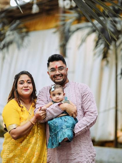 The whole family together, smiling for the camera. This photo from a first birthday shoot shows our ability to capture happy, relaxed group portraits in an outdoor setting.