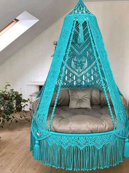 A sky-blue macrame swing that brings a cool and calming vibe. The intricate design on the canopy adds a touch of sophistication.