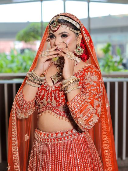 This pose highlights the intricate details of the eye makeup and the traditional jewelry. The skin has a beautiful, dewy finish.