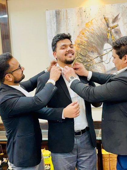 Two seniors joining in to help a new advocate with his bands. This shows our collective commitment to welcoming and supporting new members of the profession.