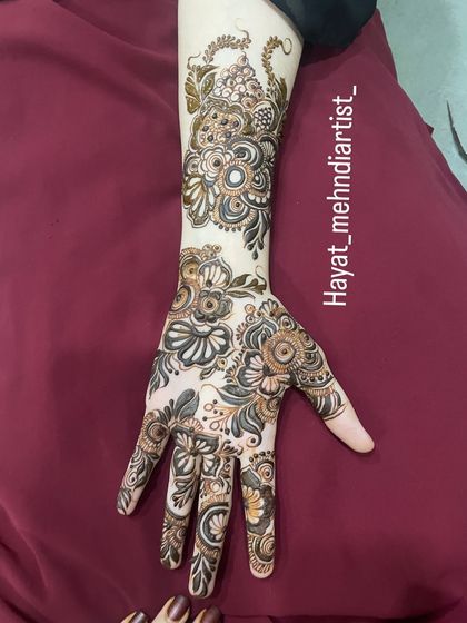 A full arm design showcasing a mix of floral and paisley motifs, perfect for a bride who wants a rich and traditional look.