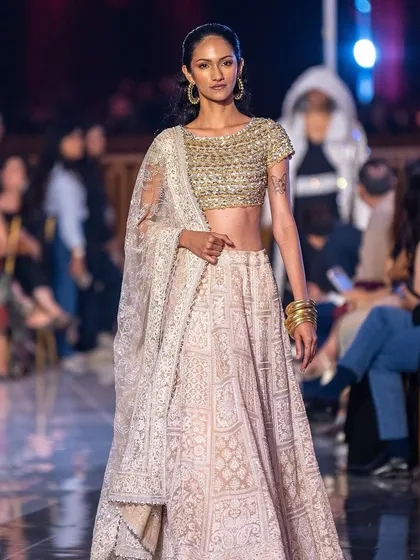 A classic, elegant makeup look for a model wearing a beautiful lehenga at the Jio World Plaza launch. The focus is on clean skin and defined eyes.