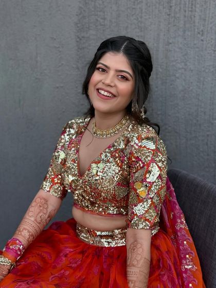 The bride looking happy and radiant in her sequined top and floral skirt. The pink eye makeup ties the whole look together.