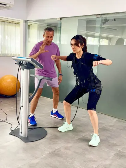 Manushi Chhillar demonstrates a dynamic move during her EMS session. Under expert guidance, each movement is amplified by the electrical impulses, making the workout both challenging and highly effective.