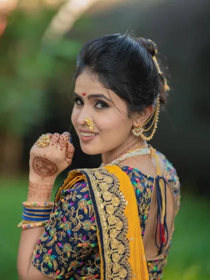 A playful glance over the shoulder. This shot shows how the makeup looks beautiful from all angles, enhancing her features without overpowering them.