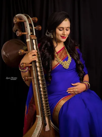 Weaving personal passions into a maternity shoot makes it truly unique. This session beautifully incorporates the client's love for classical music with the elegance of a traditional saree and Veena.
