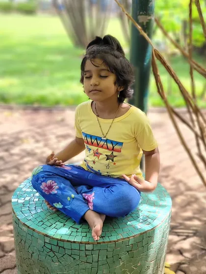 I believe mindfulness is a gift we can give children from an early age. This little one is finding her moment of peace during one of our outdoor kids' meditation sessions in the park.