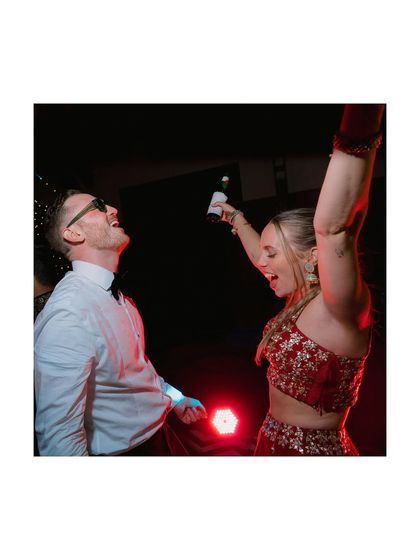 Pure joy on the dance floor. This shot captures the couple letting loose during their reception, a moment of unfiltered happiness and celebration.