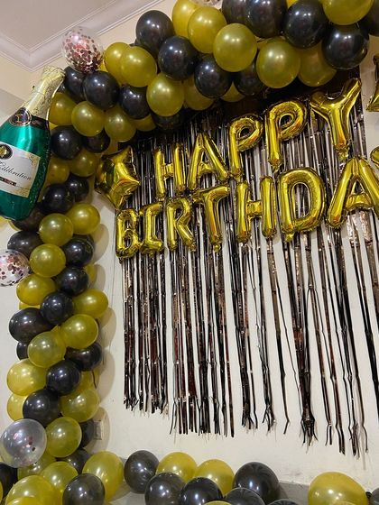 A detailed shot of the balloon arch and foil curtain backdrop.