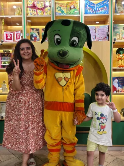 A mother and son pose with Tinga Dojo, capturing a special family moment during their visit.