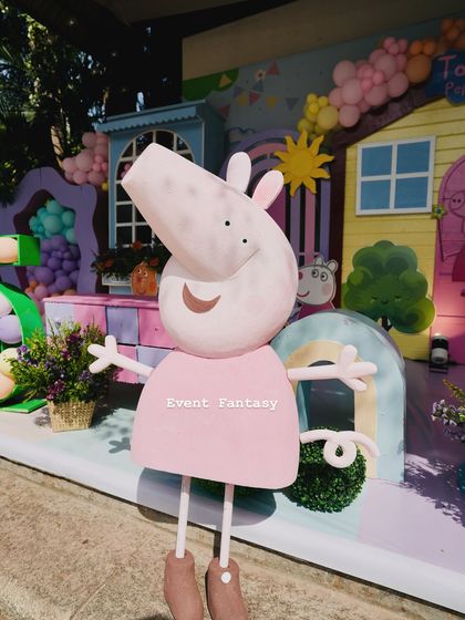A large, friendly cutout of Peppa Pig, ready to welcome guests to the party.