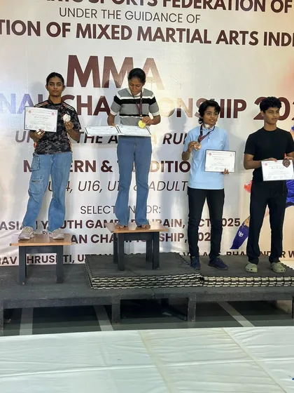 Divya on the podium with her silver medal at the FMMAI National MMA Championship. Every competition is a learning experience that forges a stronger fighter.