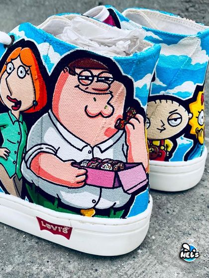 A detailed shot of Peter and Lois Griffin on the custom Levi's sneakers. The artwork captures their signature looks from the show.