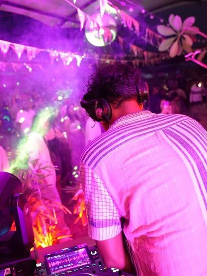 A DJ spinning tracks at our Social Sunday Sundowner, keeping the dance floor alive with incredible vibes.