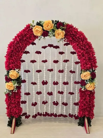 This still shot highlights the bold colors of this traditional red and yellow floral arch, a perfect festive piece for your home.