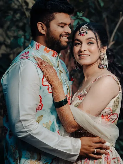 A lovely couple portrait from their Haldi ceremony. The bride's makeup is soft and natural, perfect for her floral lehenga.