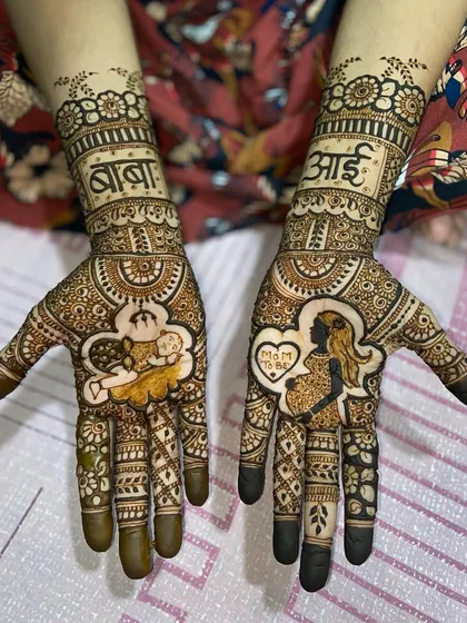 A clear, full view of the maternity-themed mehandi, showcasing the portrait work and surrounding traditional patterns.