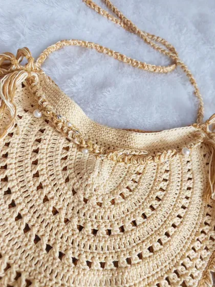 A close-up of the delicate pearl beading along the top edge of the Callaia Bag.