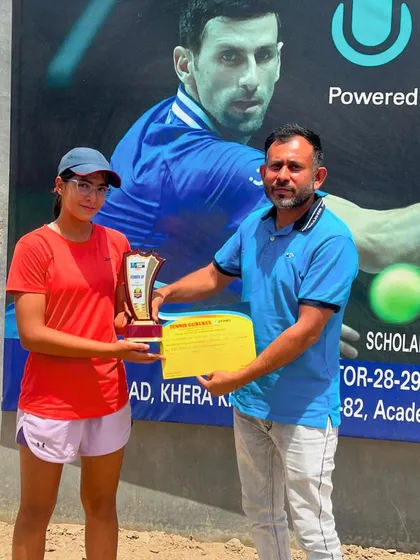 Eshanya Khattar, a finalist in the U18 Girls' category, receives her award at a UTR tournament. We celebrate every step of the journey, including reaching the finals.