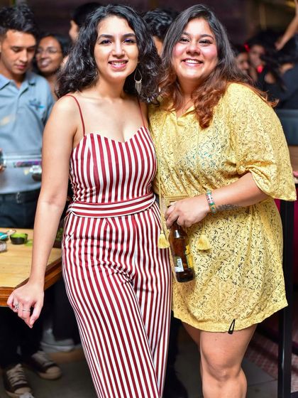 Two friends enjoying the relaxed and happy vibe of a weekend party.